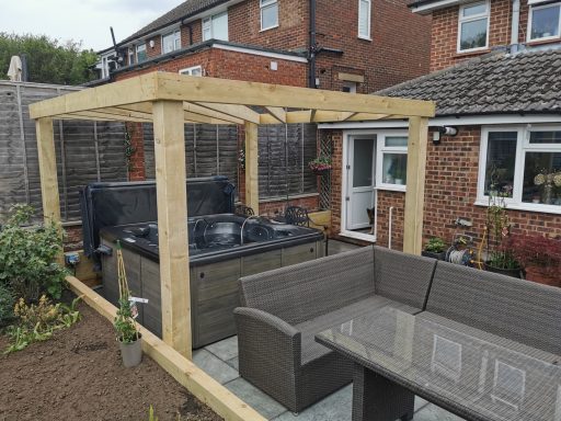 Garden gazebo with an outdoor seating area and a barbecue grill.