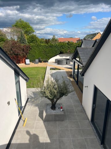 Landscaping project in Marlow featuring porcelain patio and raised planters by ESI Building